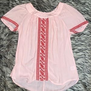 Pink shirt with red stitching